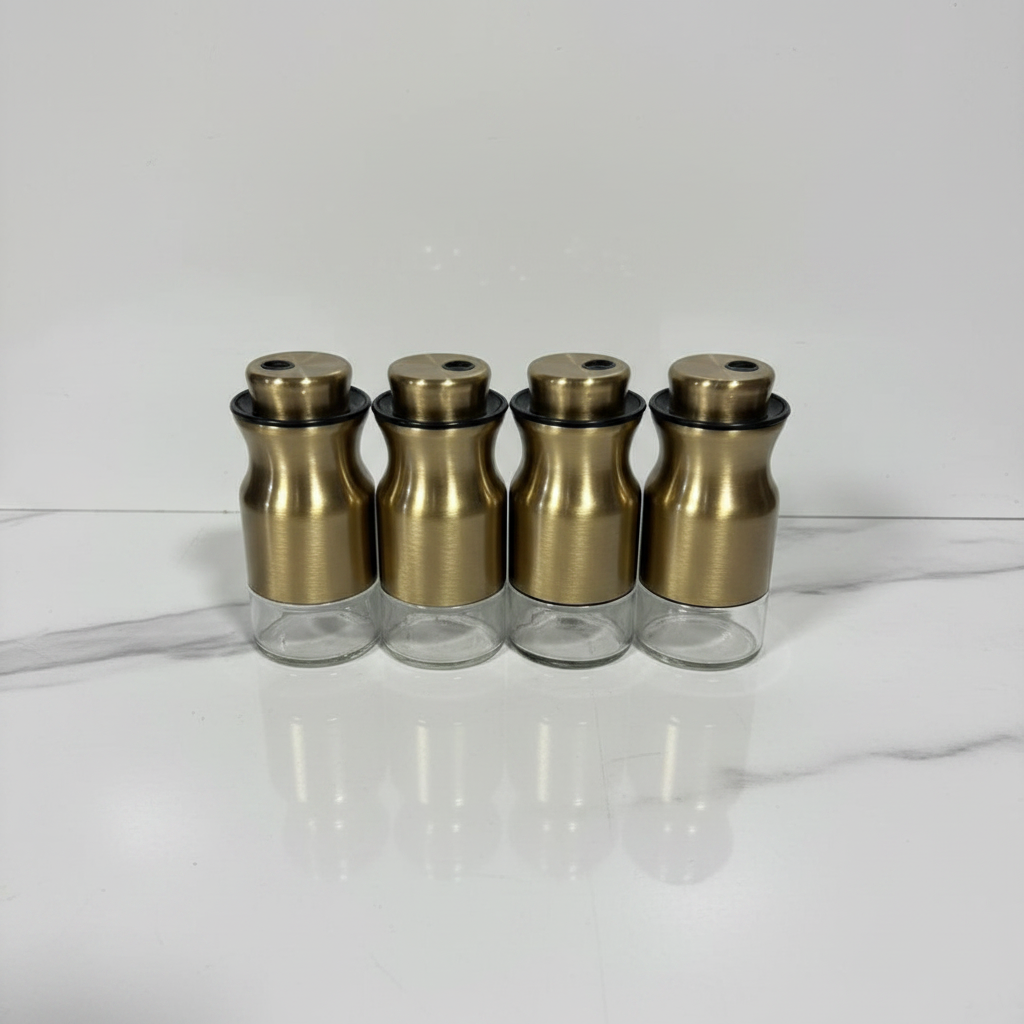 4 gold spice jars lined up in a row — professional studio shot