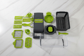 All 16 pieces flat lay — blades, graters, colander and accessories