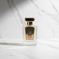 MUD Musk & Oud dark gold perfume bottle on marble background